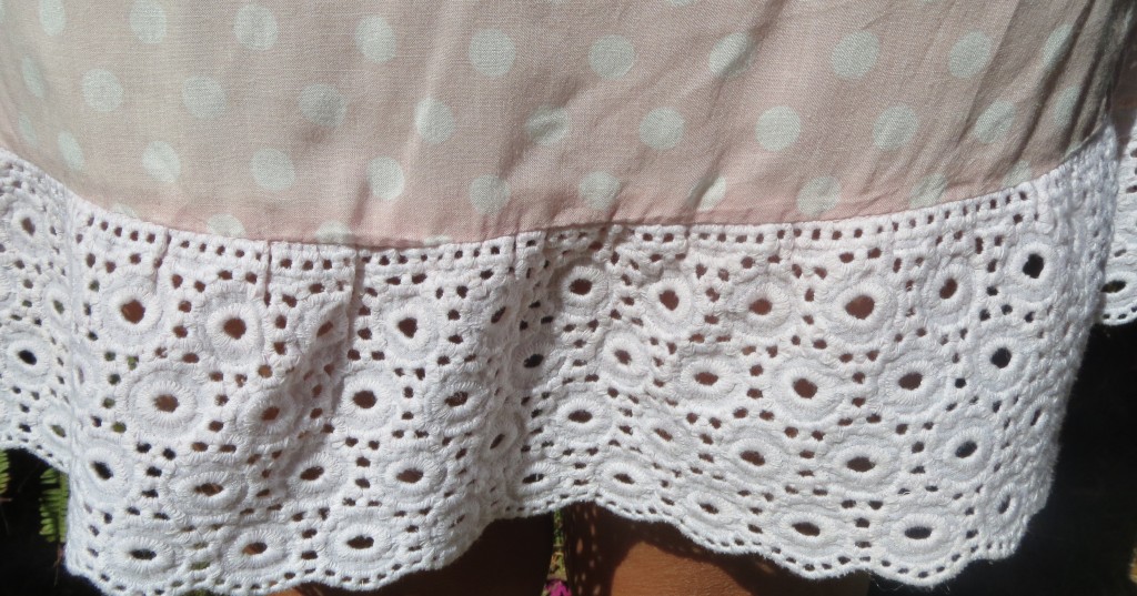 Pink polka-dot strapless dress, close up